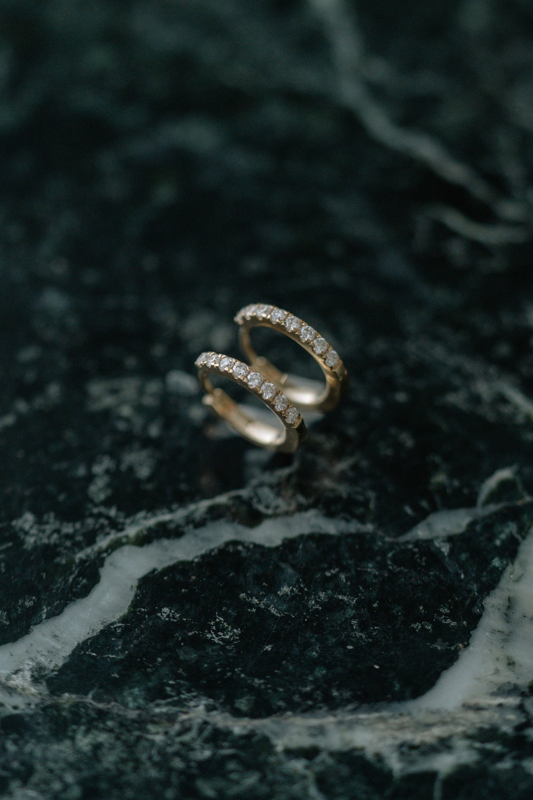 BB Classic Diamond Huggies by Lane &amp; Kate in 14kt yellow gold with a row of diamonds, on green marble