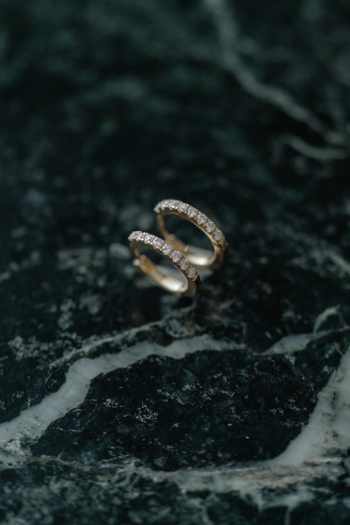BB Classic Diamond Huggies by Lane &amp; Kate in 14kt yellow gold with a row of diamonds, on green marble