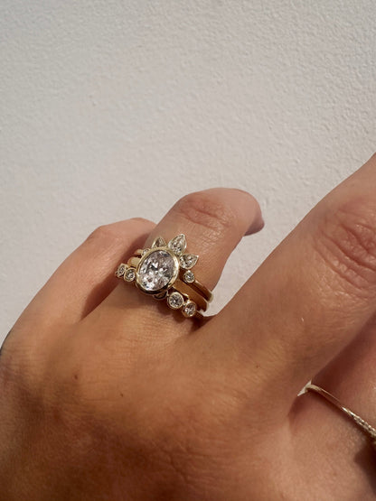 Diamond Deity wedding band in 14kt yellow gold with bezel set round diamonds worn on the hand