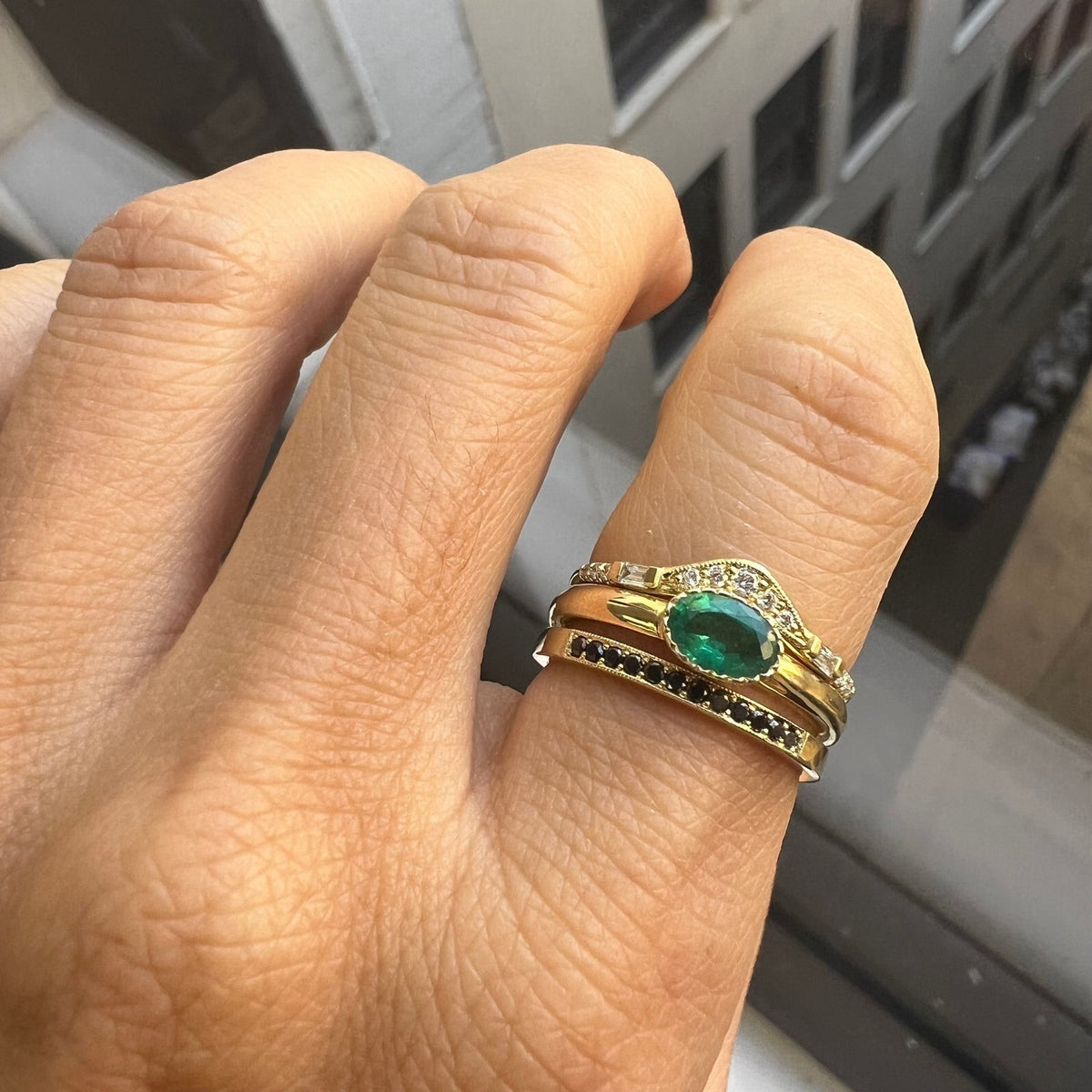 Jennie Kwon Emerald Chubby Ring styled in a ring stack