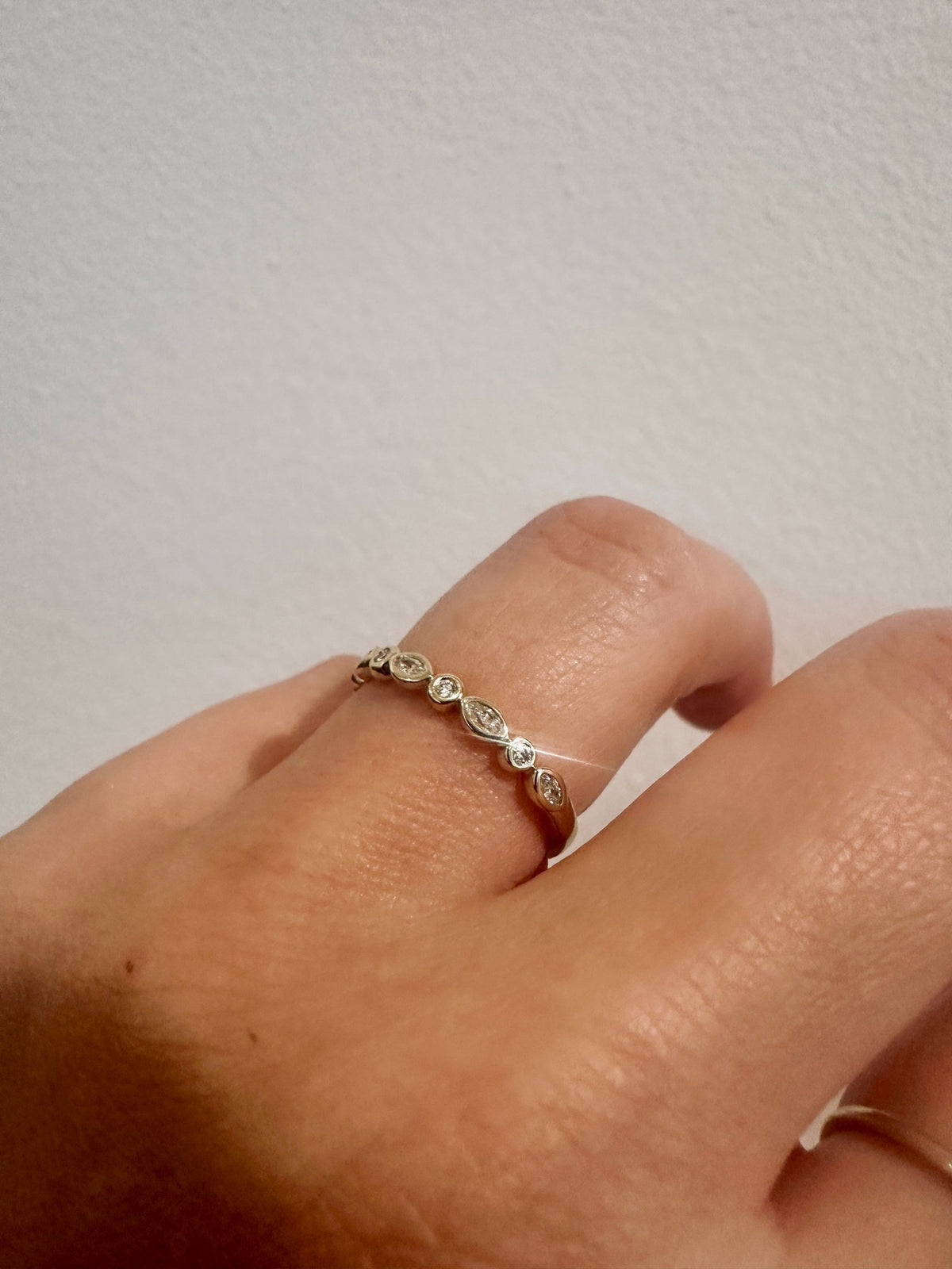 Diamond Harmony wedding band in 14kt yellow gold with marquise and round diamonds worn on the hand