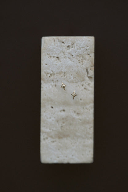 Petite Golden Stars by Lane &amp; Kate, tiny 14kt yellow gold star studs on travertine