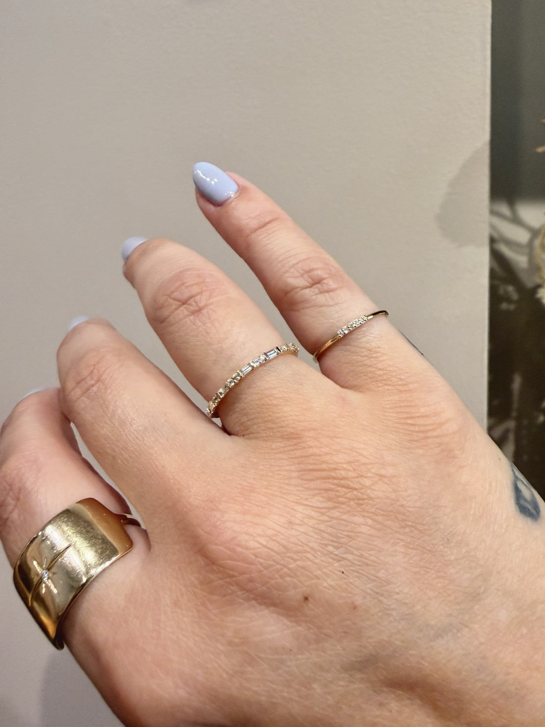 Baguette Daylight band with baguette and round diamonds in 14kt yellow gold worn on the hand