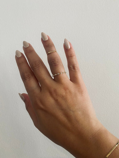 Heavenly Dew Wedding Band with seven round diamonds worn on hand