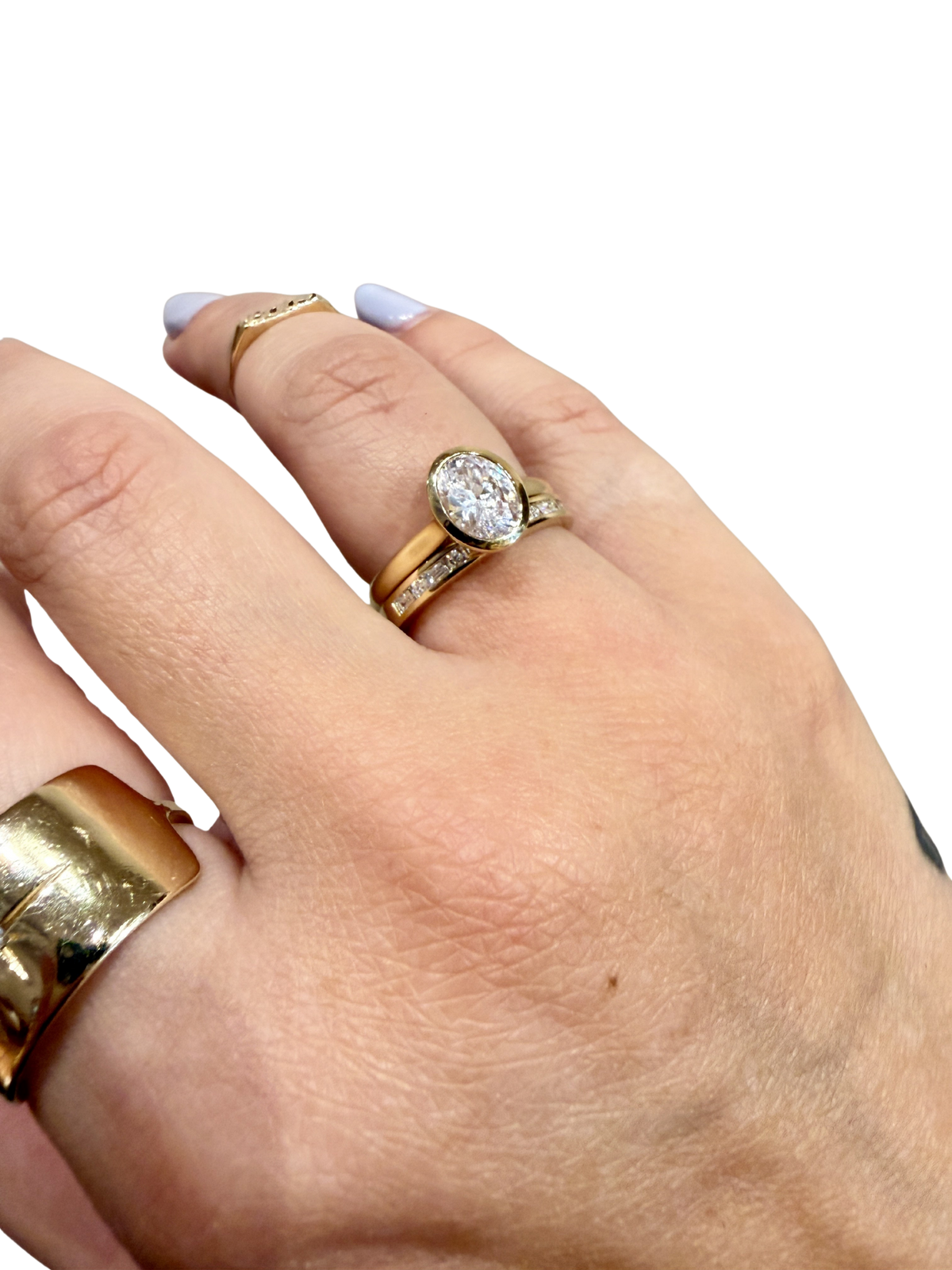 Baguette Rivulet Wedding Band by Lane &amp; Kate, worn stacked with an oval engagement ring