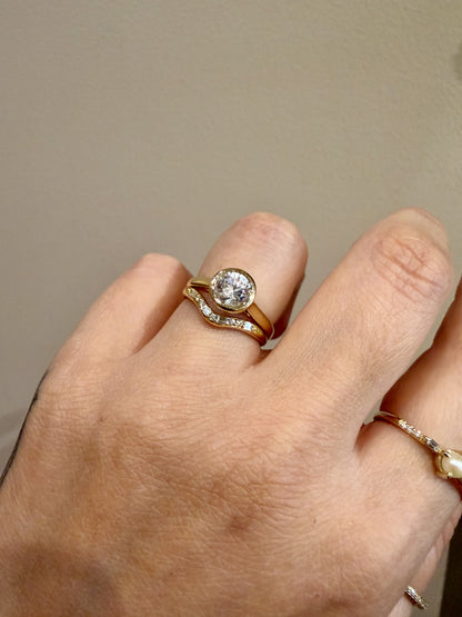 Jennie Kwon Diamond Staccato Wave Band with baguette and round diamonds in 14kt yellow gold paired with a bezel set round engagement ring