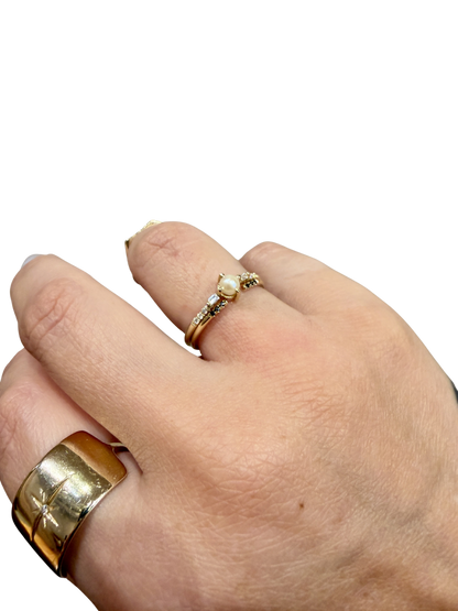 Black Equilibrium Cuff and Solo Pearl Baguette Equilibrium Ring by Jennie Kwon, worn together on the hand