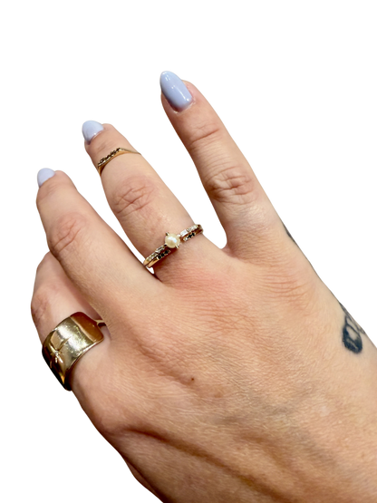 Black Equilibrium Cuff ring by Jennie Kwon with black diamonds, worn stacked on the hand