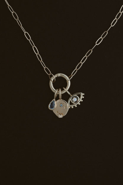 Paperclip Circle Charm Necklace by Lane &amp; Kate in 14kt yellow gold, shown holding charms