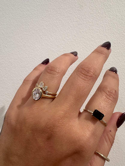 Bezel set pear diamond contour band stacked with an oval engagement ring