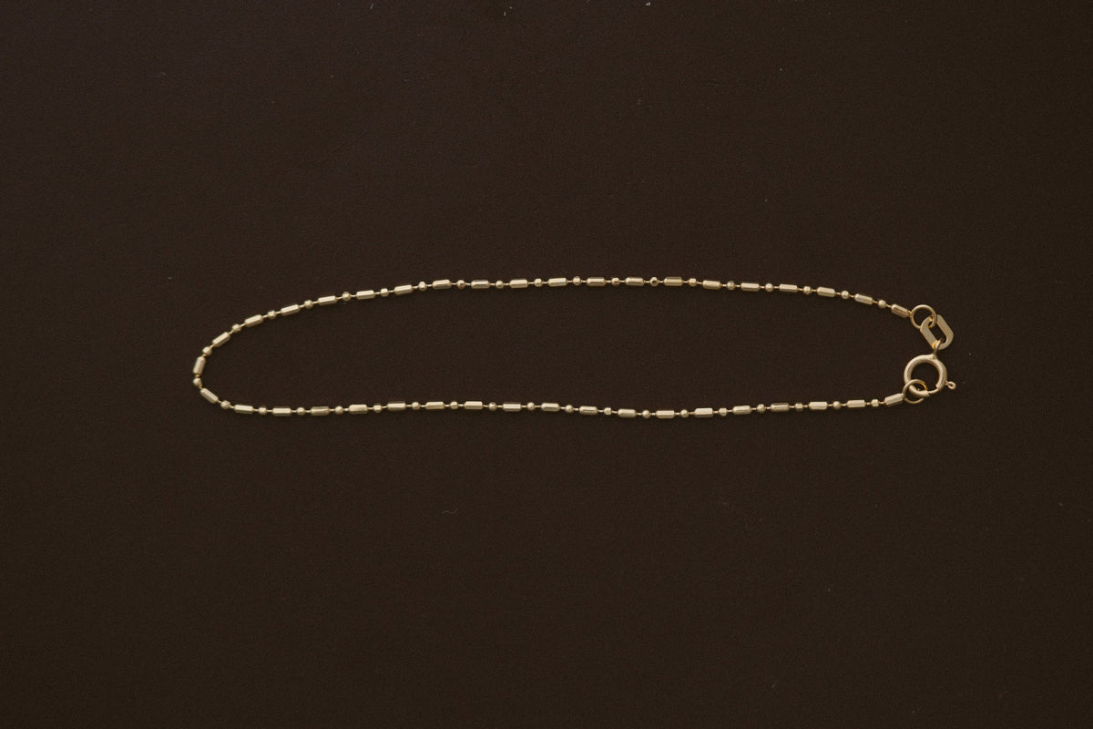 Bar &amp; Tube Petite Chain Bracelet by Lane &amp; Kate, laid flat with spring ring clasp