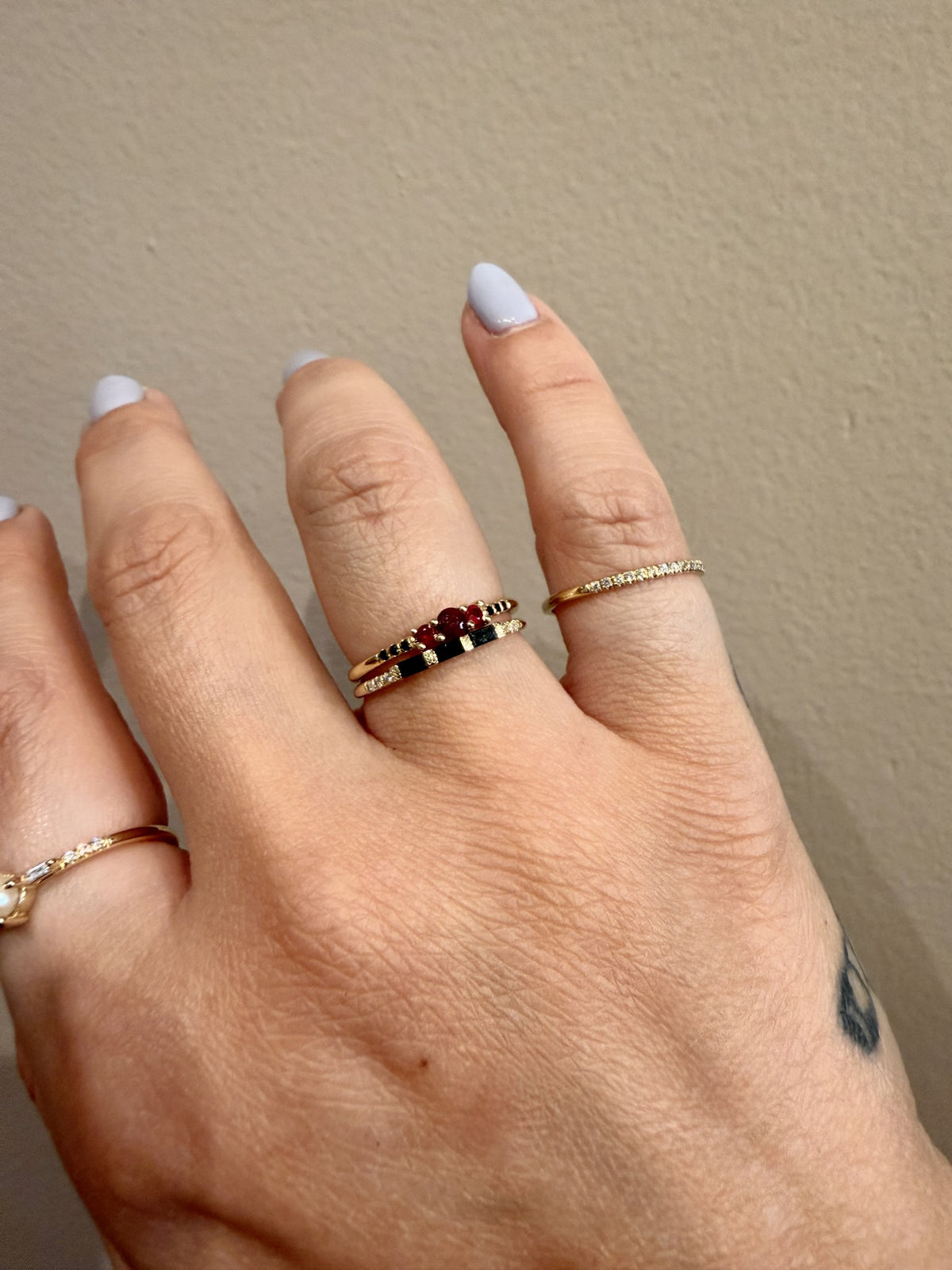 Three Black Diamond Baguette Band in 14kt yellow gold stacked on the hand