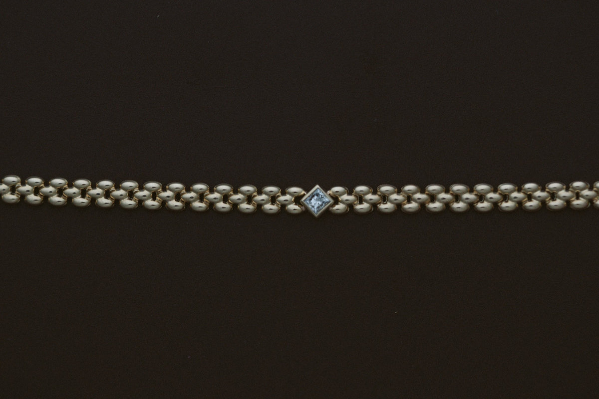Princess Diamond Panther Bracelet by Zoe Chicco, laid flat showing the princess diamond station