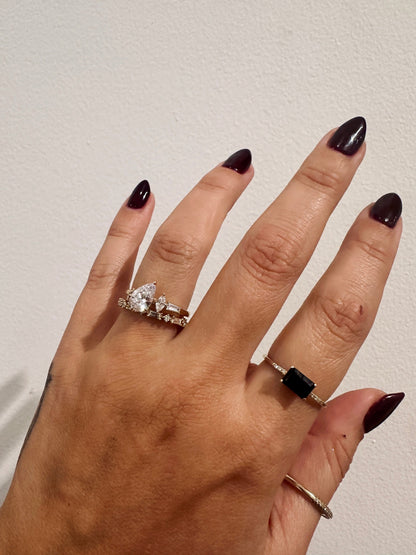 Golden Dusk Wedding Band stacked with a pear diamond engagement ring