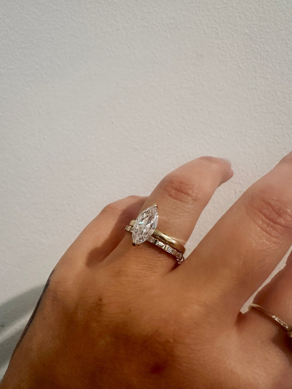 Baguette Sol wedding band in 14kt yellow gold with baguette diamonds worn on the hand