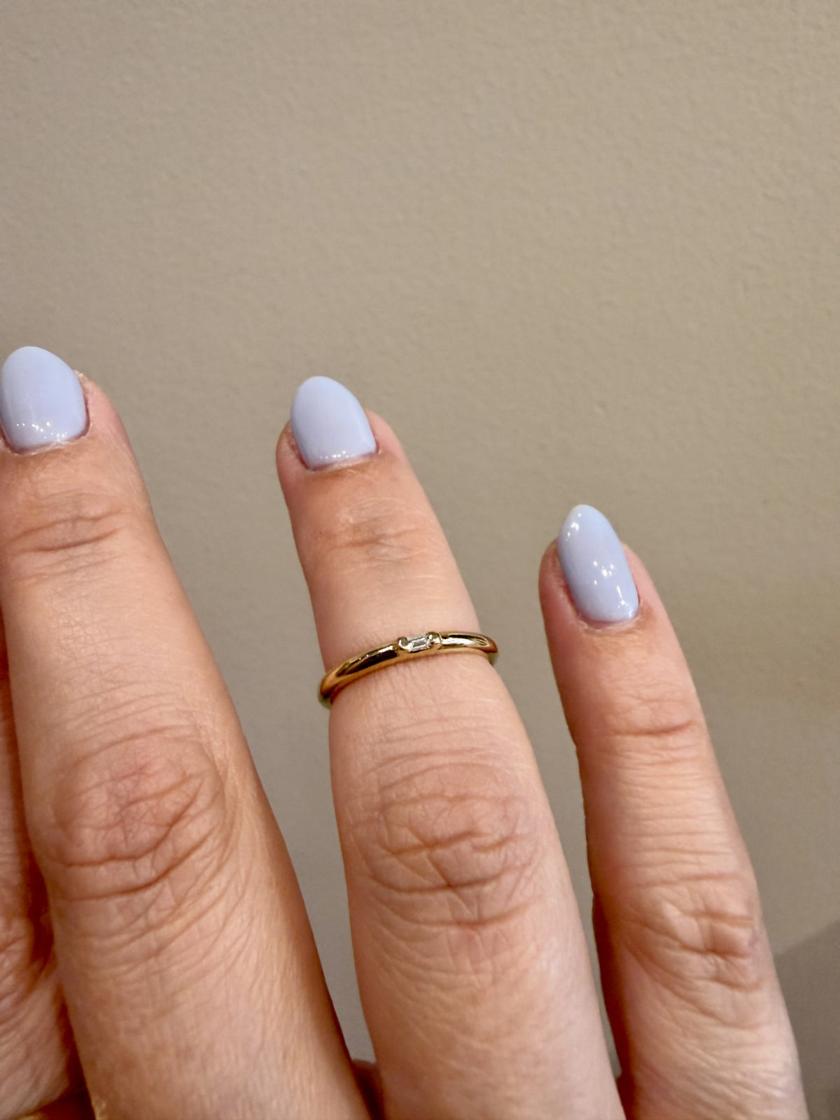 Diamond Baguette Accent Ring with a single baguette diamond in 14kt yellow gold worn on the hand