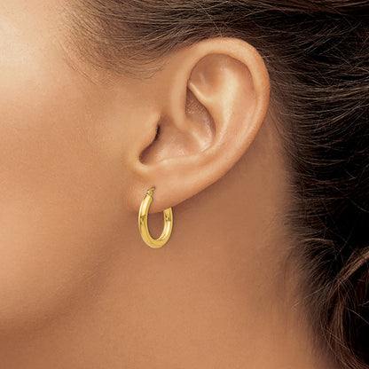Thick Boi Hoops in 14kt yellow gold worn on model