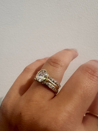 Diamond Dew wedding band in 14kt yellow gold with prong set round diamonds worn on the hand