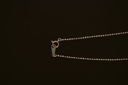 BB Ball Chain in 10kt yellow gold with spring ring clasp on a dark background