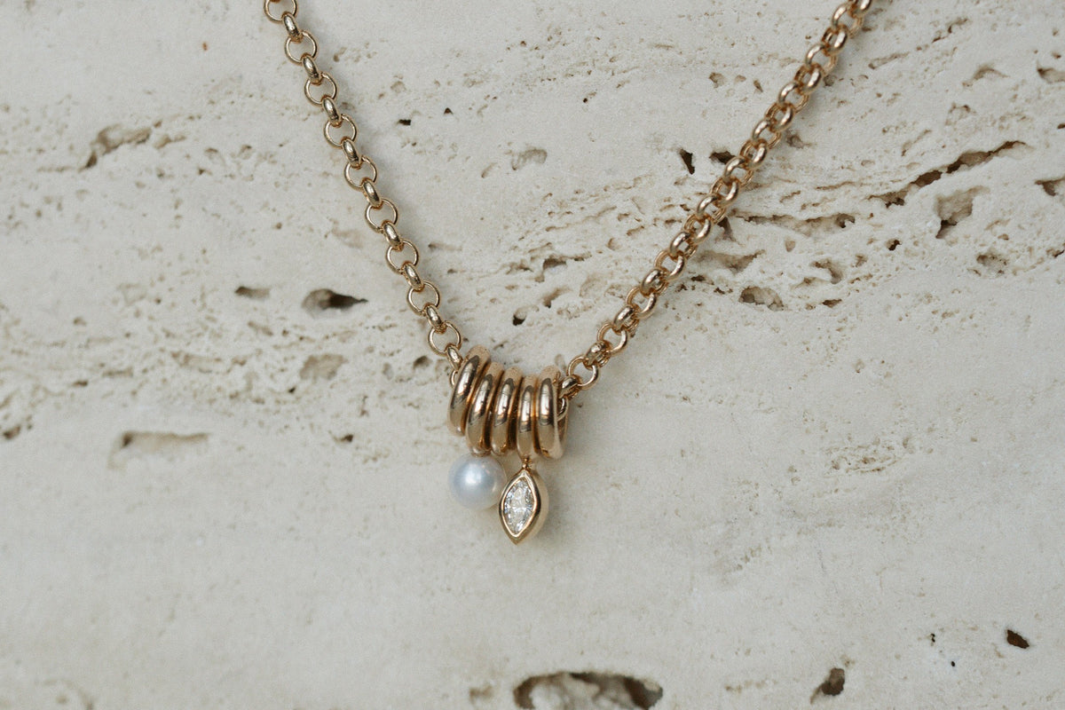 Zoe Chicco Mixed Rings Diamond Necklace on travertine, close up
