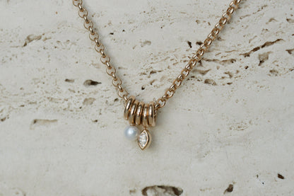 Zoe Chicco Mixed Rings Diamond Necklace on travertine, close up