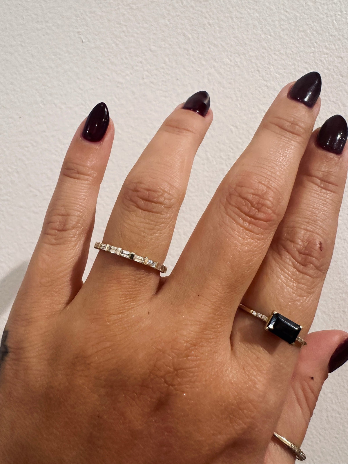 Baguette Sol wedding band in 14kt yellow gold with baguette diamonds worn on the hand