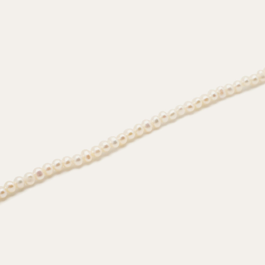 Pearl Rice Bracelet by Gjenmi, a strand of hand strung freshwater baby pearls